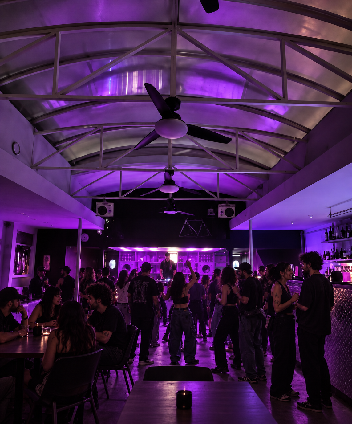 Crowd beneath the vaulted ceiling in violet light