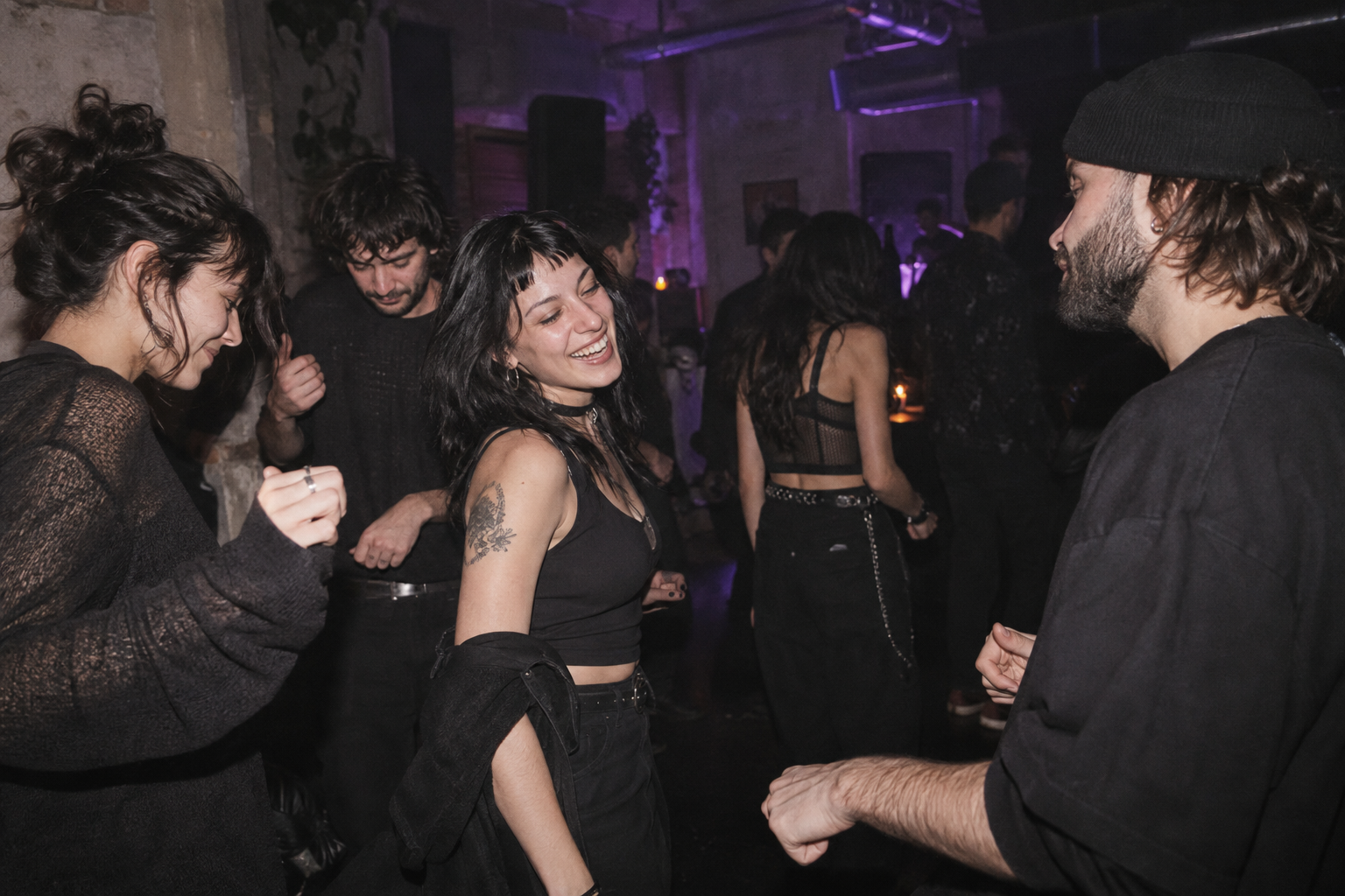 Friends dancing under violet lights